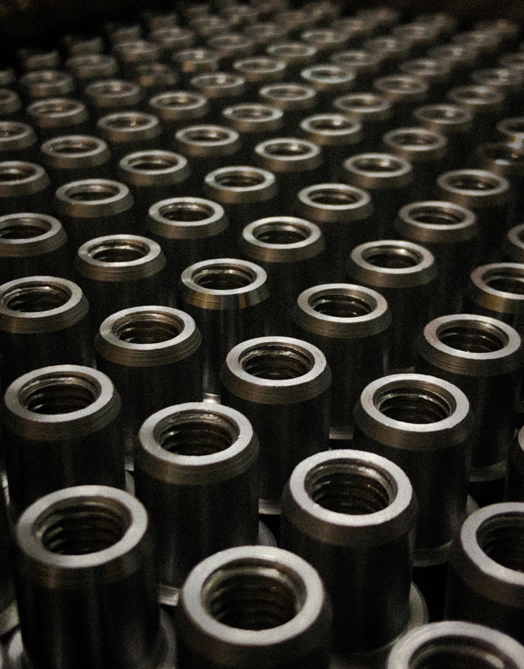 Rows of precision-machined threaded metal components